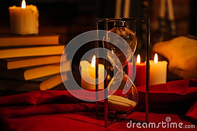 Magic composition with skull, candles, magic book and hourglass. the occult concept of black magic ritual. Stock Photo