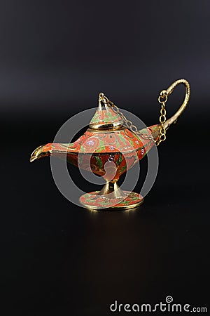 Magic lamp of Alladin on a dark and light background. Stock Photo