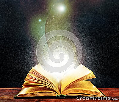 Magic light emanating from open old book Stock Photo