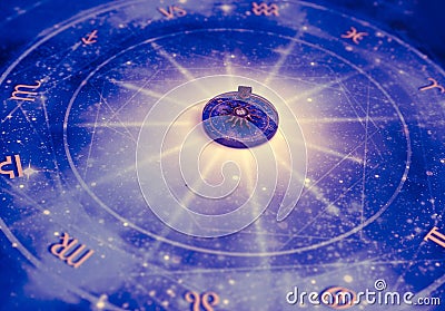 Magic pendant on blue horoscope like astrology, zodiac. esoteric topic Stock Photo