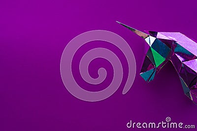 A magic unicorn made of foil on a purple background Stock Photo