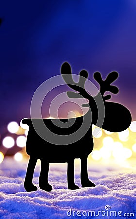 Magic winter christmas background with christmas lights, silhouette deer and snow at night Stock Photo