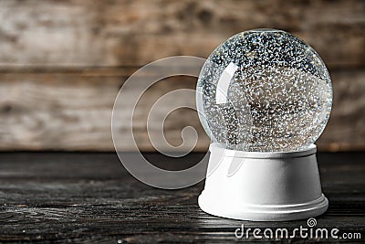 Magical empty snow globe on wooden table. Stock Photo