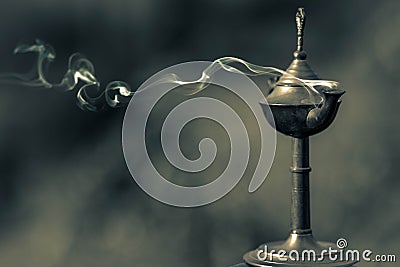 A magical genie lamp with smoke. Old Oriental Aladdin lamp with smoke Stock Photo