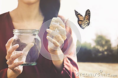 Magical moment of a woman who gives freedom to a butterfly Stock Photo