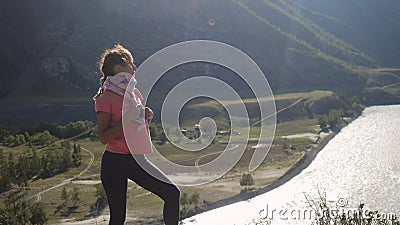 Magical and mystic girl looking to the coast of the mountain river from a cliff looking beautiful landscape. Stock Photo