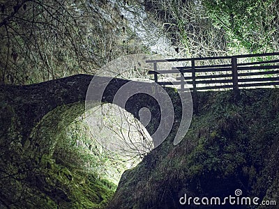 Magical old bridge,by night, light behind. Stock Photo