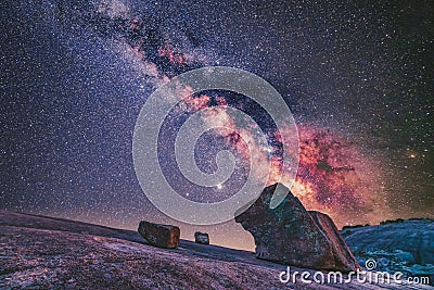 Magical scenery of rocks in the mountains under the mysterious galaxy sky Stock Photo