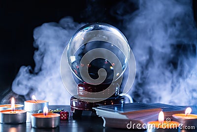 Magician or fortune teller is predicting future with crystal sphere. Stock Photo