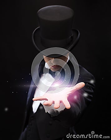 Magician holding something on palm of his hand Stock Photo