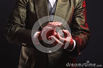 Magician shows trick with a coin. Manipulation with props. Sleight of hand. Stock Photo