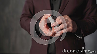 Portrait of a young man with gambling. Dexterous hands of a magician on a brown texture. The concept of entertainment Stock Photo
