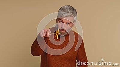 Magician witch senior man gesturing with magic wand making wish come true, casting magician spell Stock Photo