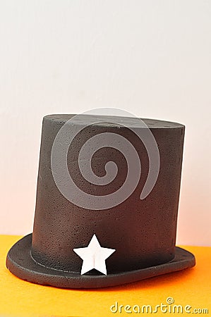 A magicians hat displayed with one silver glitter star Stock Photo