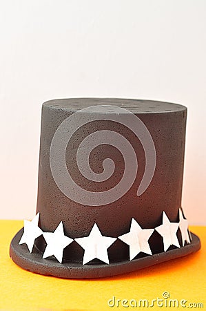 A magicians hat displayed with a row of silver glitter stars Stock Photo
