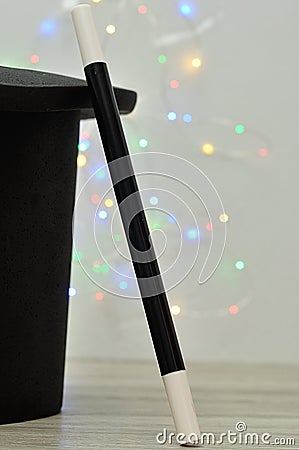 A magicians hat and wand against an out of focus light background Stock Photo