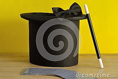 A magicians hat, wand, bow tie and a deck of cards Stock Photo