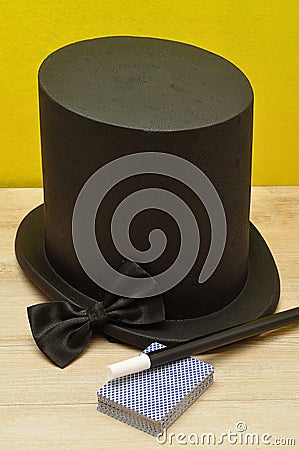 A magicians hat, wand, bow tie and a deck of cards Stock Photo