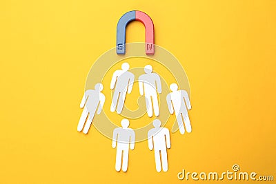 Magnet attracting people traffic on color background Stock Photo