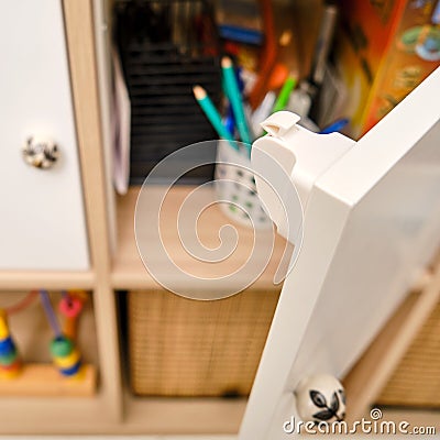 Magnetic child-proof lock for locking cabinet doors and drawers of home furniture Stock Photo