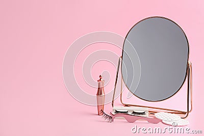 Magnetic eyelashes and accessories on pink background. Space for text Stock Photo