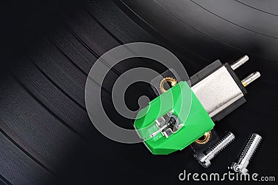 Magnetic phono cartridge and screws on vinyl record Stock Photo