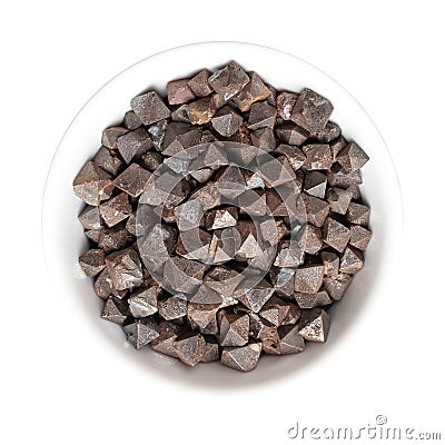 Magnetite crystals, octahedral, double pyramid shaped, in white bowl Stock Photo