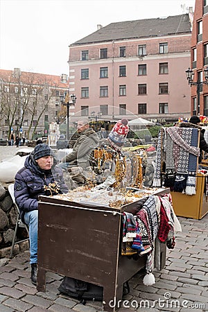 Riga, Latvia, November 2019. Souvenir dealers in the square awaiting buyers. Editorial Stock Photo