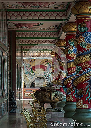 The magnificent of Chinese-style temple corridor with sculptured dragons pillars, Large incense burner decorated with dragon Stock Photo