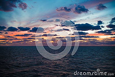 Magnificent evening sky over Pacific Ocean. Sunset behind clouds. Stock Photo