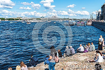 Russia, St. Petersburg, July 2020. People resting on a small beach in the center and a view of the Neva River. Editorial Stock Photo