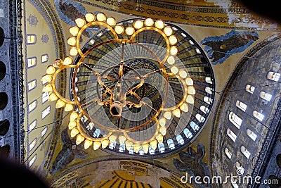 Magnificent lightning chandelier with candles and interior dome background and details of Hagia sophia. Editorial Stock Photo