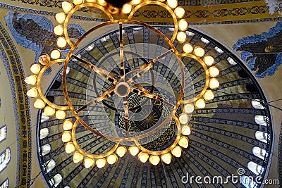 Magnificent lightning chandelier with candles and interior dome background and details of Hagia sophia. Editorial Stock Photo