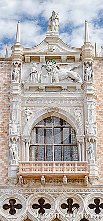 Magnificent main facade with luxurious balcony and statues with roof decorations of Doge Palace in Venice at San Marco square, Stock Photo