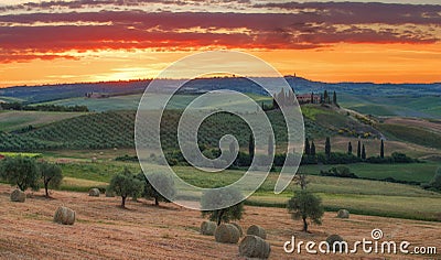 Magnificent spring landscape at sunrise.Beautiful view of typical tuscan farm house, green wave hills. Stock Photo