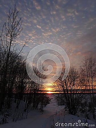 Magnificent sunset on a frosty winter evening on the river. Stock Photo