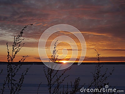 Magnificent sunset on a frosty winter evening on the river. Stock Photo