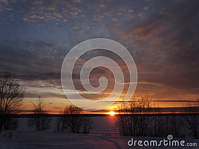 Magnificent sunset on a frosty winter evening on the river. Stock Photo