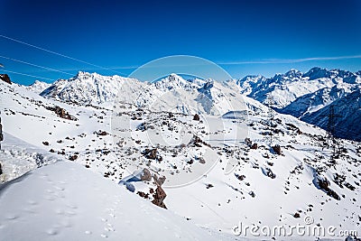 Magnificent view of the snow-white towering mighty mountains Elbrus and the cable ways, ski resort, Kabardinobalkaria, Russia Stock Photo