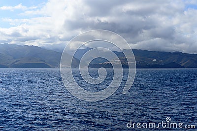 Magnificent views from the high seas with a beautiful enraged sky as a background the island of La Gomera. April 15, 2019. La Stock Photo