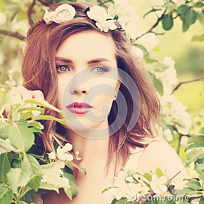 Magnificent Woman with Spring Blossom Background Stock Photo