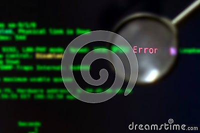 The magnifier is on a black background with green blurred text, selective focus. Software testing. The concept of finding errors Stock Photo