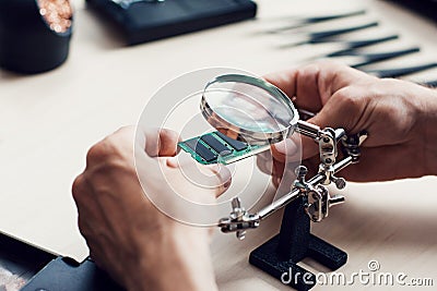 Magnifier in electronic repair shop Stock Photo