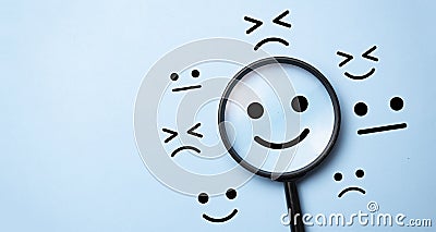 magnifier glass and emotion signs.Customer satisfaction and evaluation after service or marketing survey Stock Photo