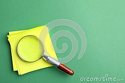 Magnifier glass and empty paper sheets on background, flat lay with space for text. Find keywords concept Stock Photo
