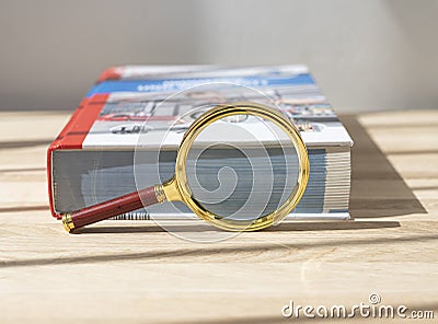 Magnifier near thick technical book for education. Concept of scientific knoledge and study Stock Photo