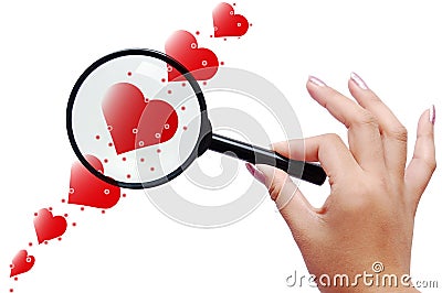 Magnifier and red hearts Stock Photo