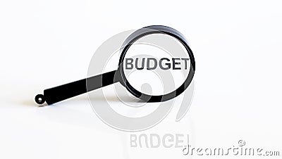 Magnifier with text BUDGET on white background Stock Photo