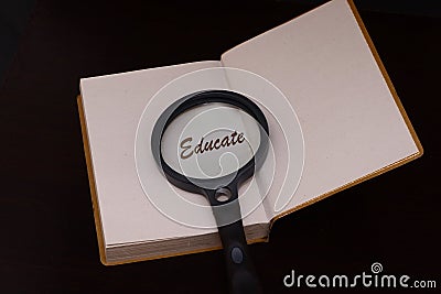 Magnifing glass on a book to help facilitate the vision for reading and to educate Stock Photo