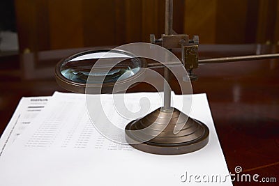 Magnifying glass and accounting reports of a company Stock Photo